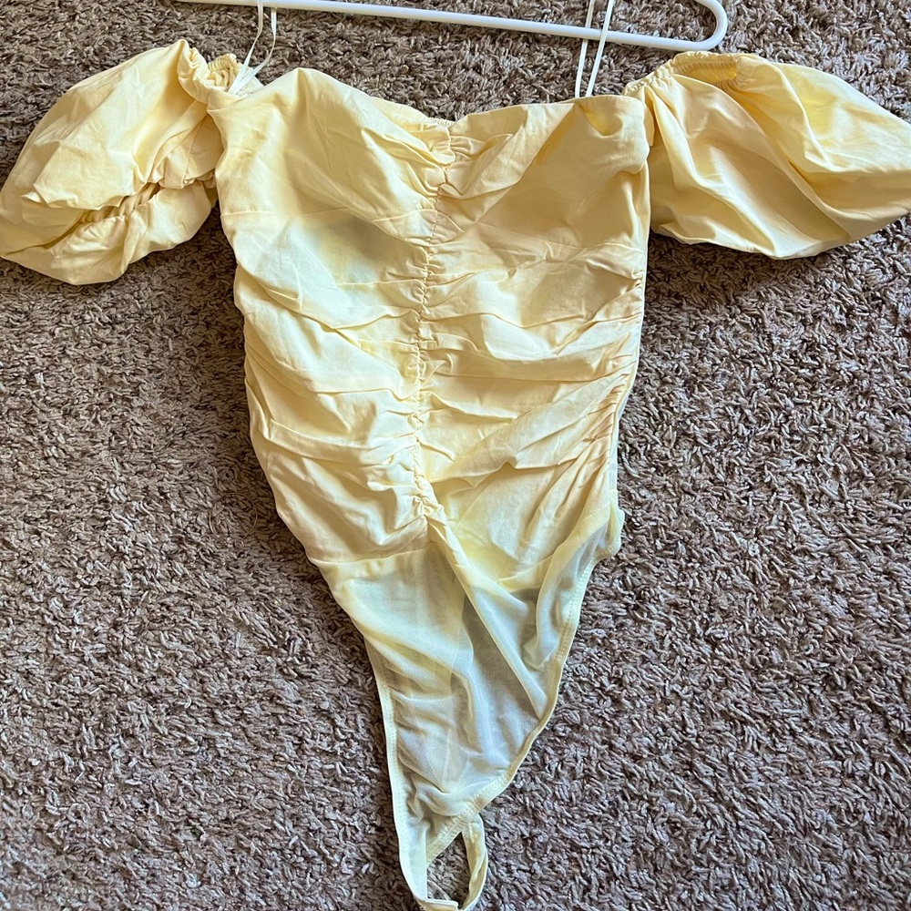 Cute cream bodysuit! Never worn but tags are not still on.